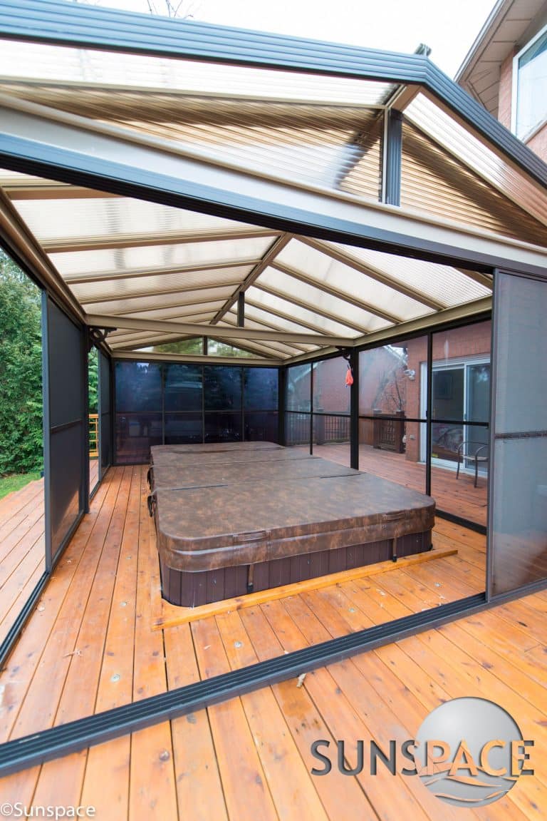 a patio cover covering an outside hot top built into a deck by Deck and Shade Solutions