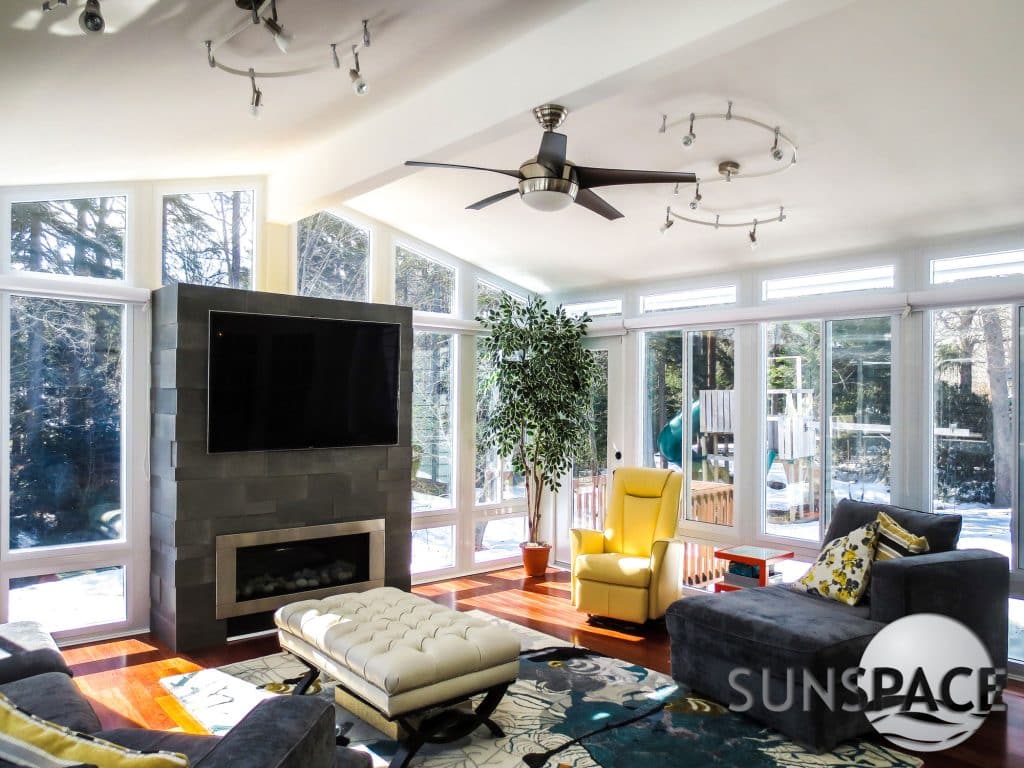 Sunroom with fireplace during the day