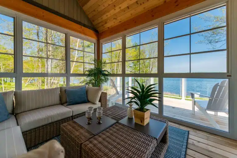 couches in a sitting area overlooking a body of water